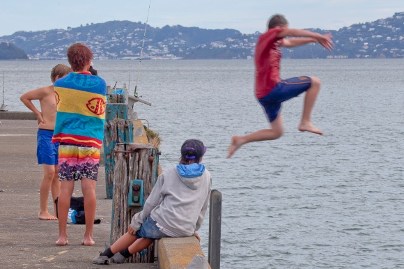 Boys leap off Petone wharf to irritate the fishermen